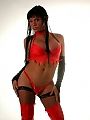A kinky ladyboy hiding her shapes under red lingerie